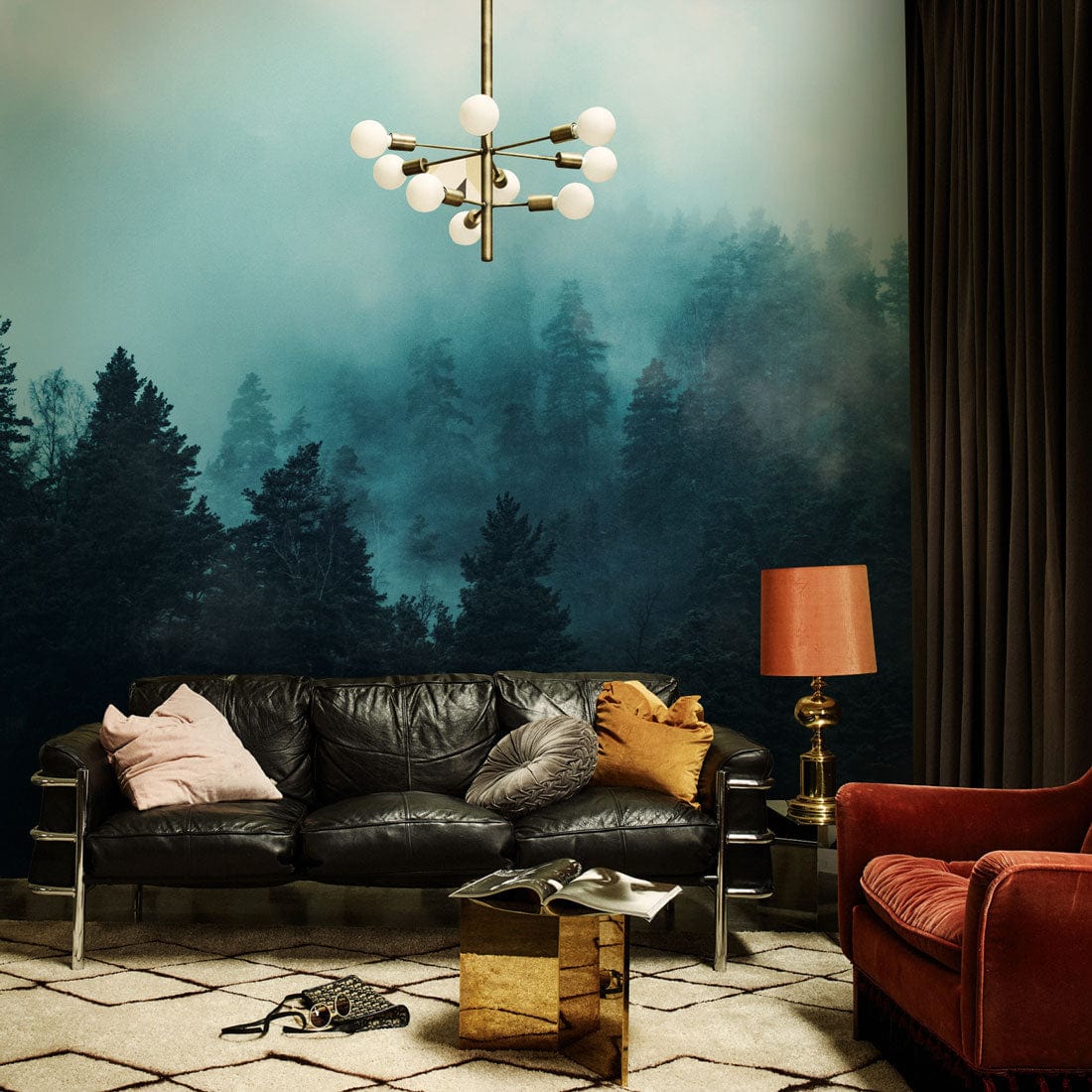 Enchanted Misty Forest Mural Wallpaper, teal, with black leather sofa, geometric rug, modern pendant light.