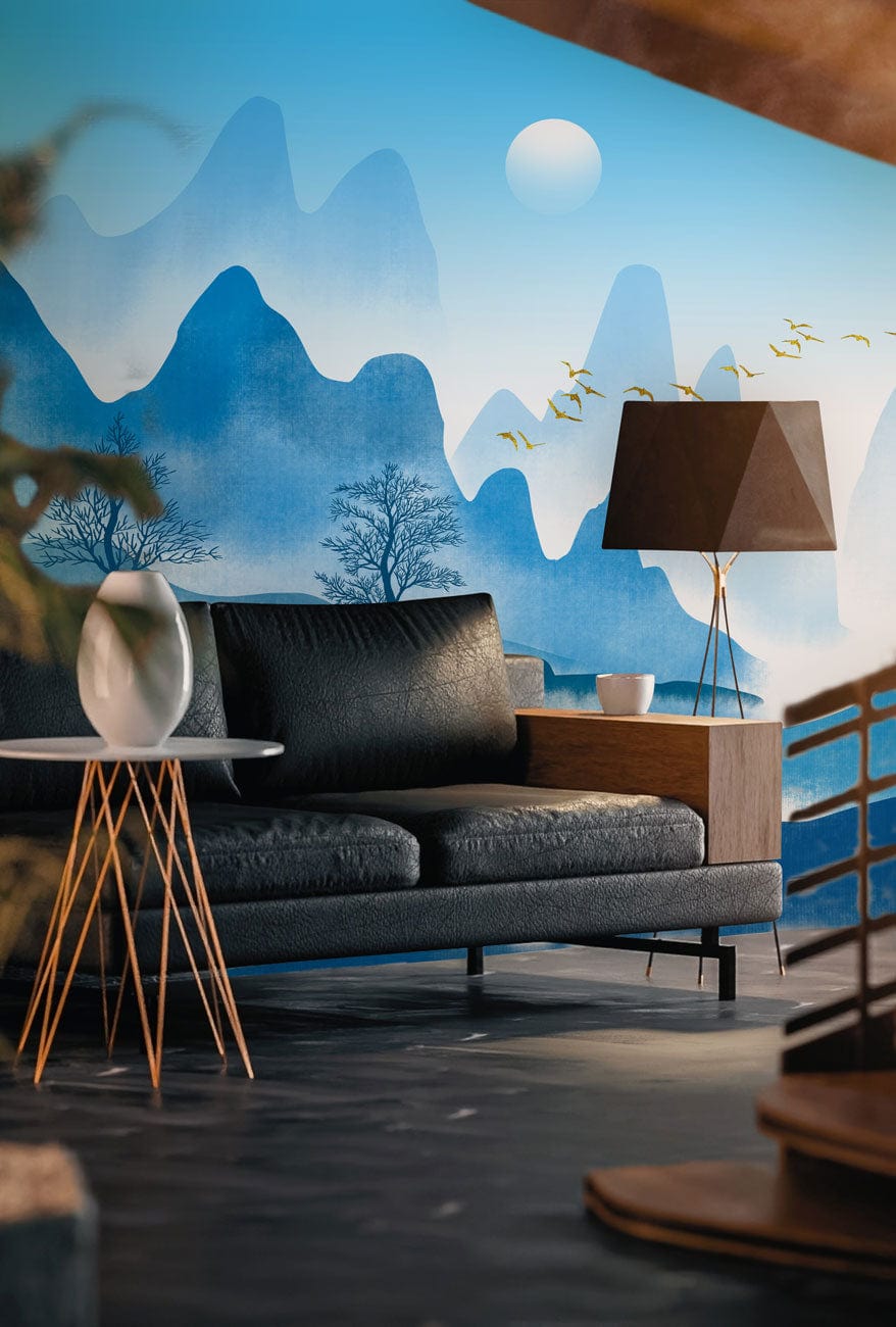 Serene Blue Mountain Landscape Mural Wallpaper, blue wall, dark sofa, modern lamp, stylish coffee table.