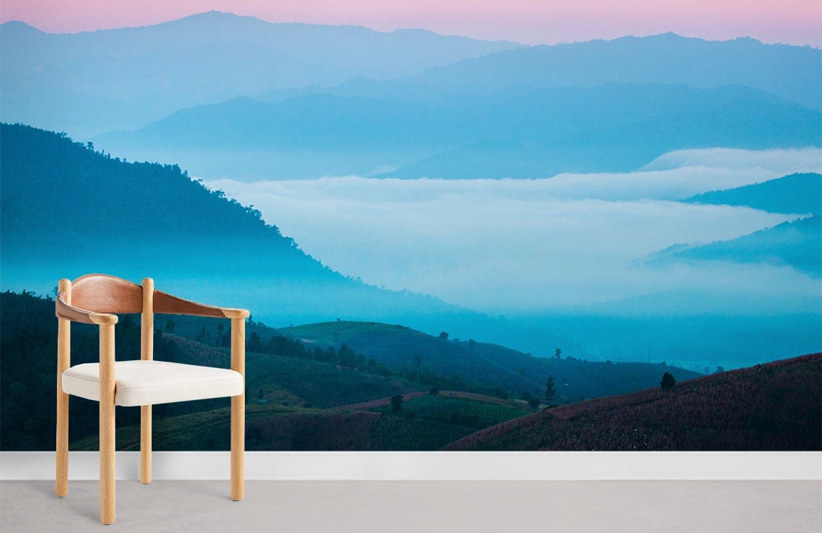 Tranquil Misty Mountain Wallpaper, pastel blue hues, wooden chair, minimalist grey floor, serene ambience.