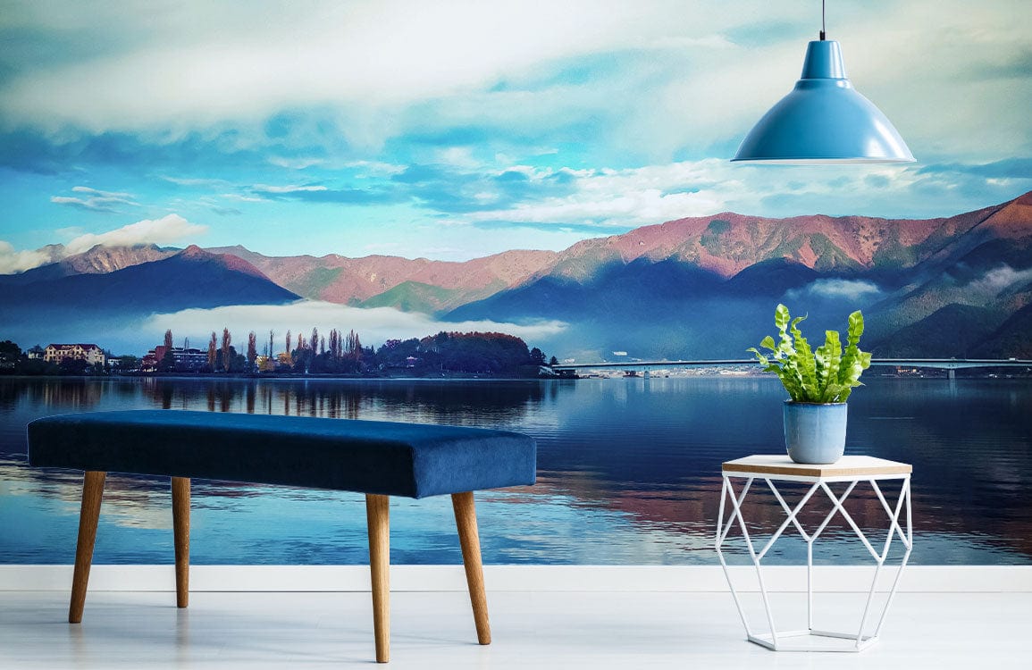 Tranquil Mountain Lake mural, serene blue theme, blue bench, geometric table, wooden flooring, pendant light.