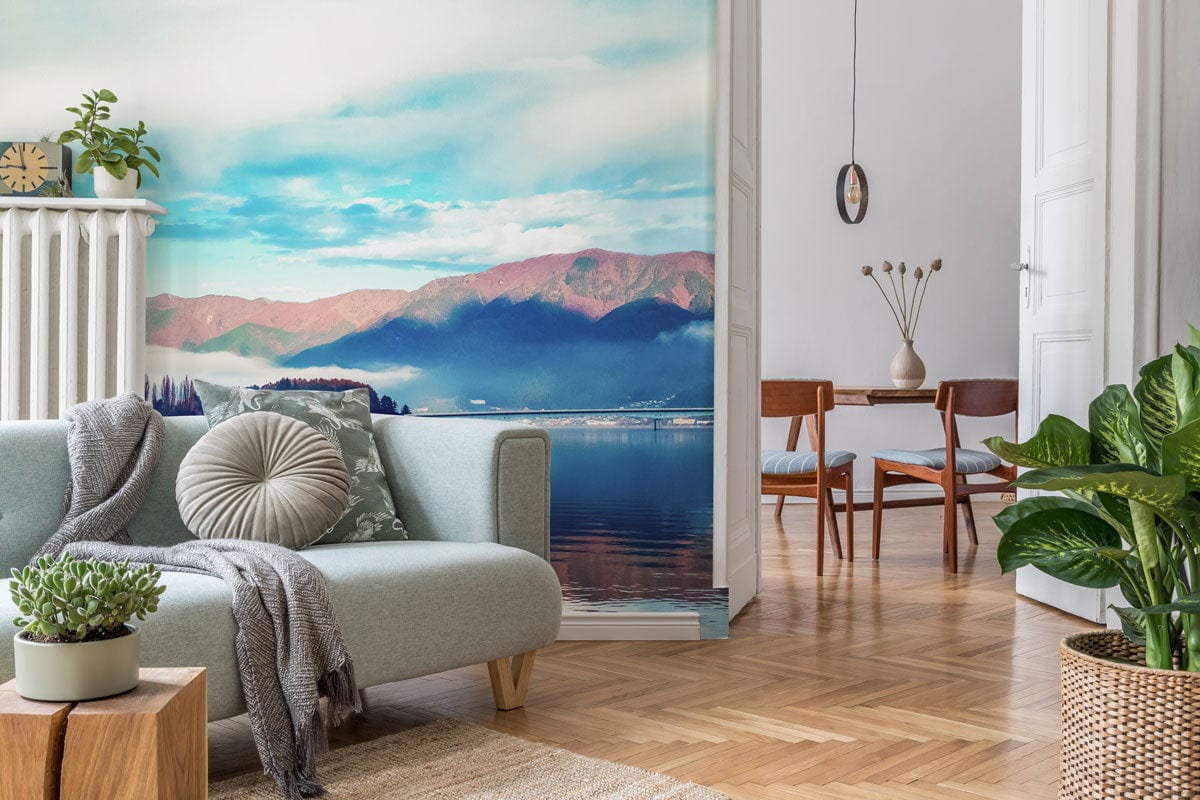Tranquil Mountain Lake mural, serene blue tones, in living room with grey sofa, wooden flooring, decor.