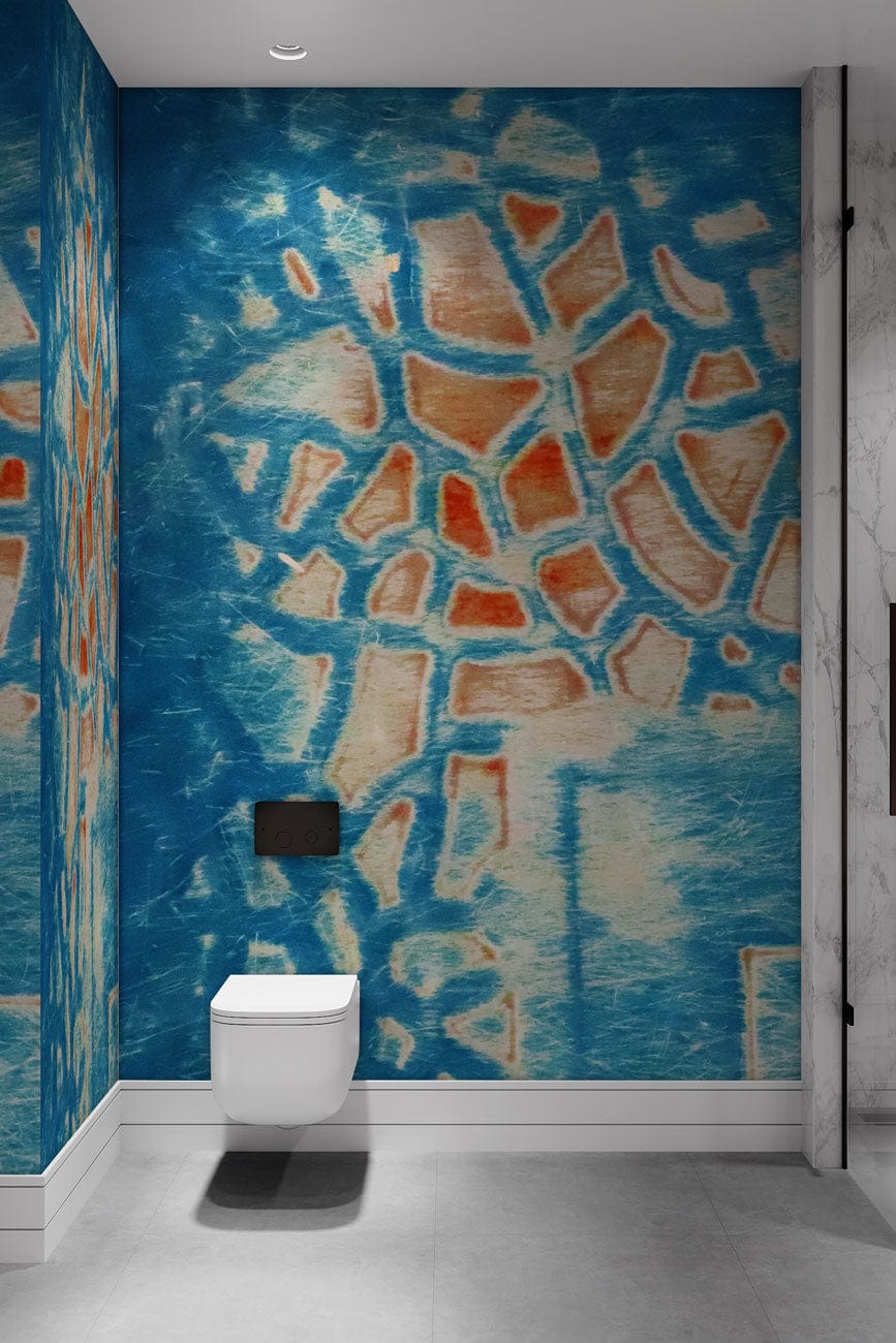 Abstract blue textured mosaic wallpaper in modern bathroom with wall-mounted toilet and light grey flooring.