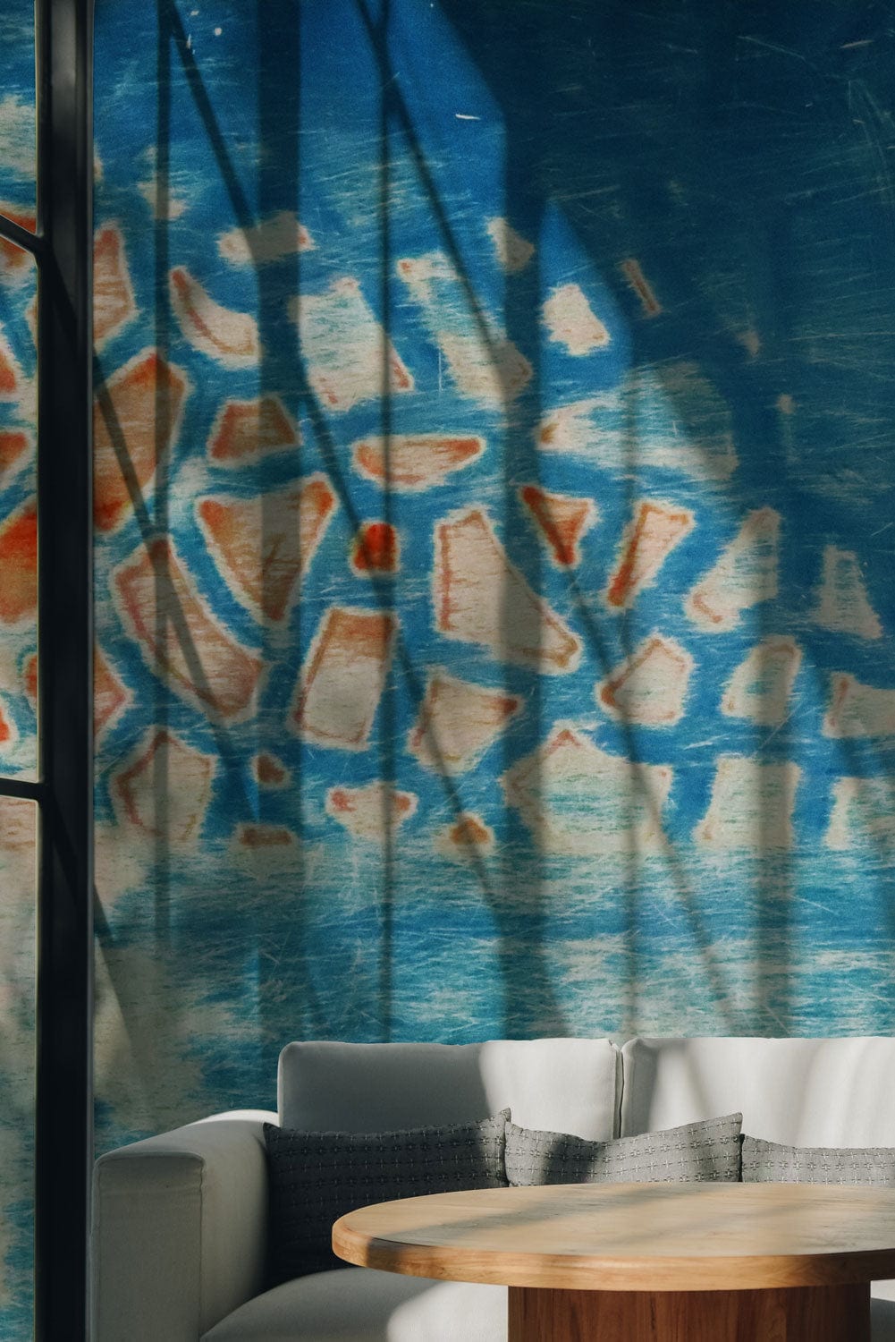 Abstract blue textured mosaic wallpaper with wooden round table and modern white sofa in living room.
