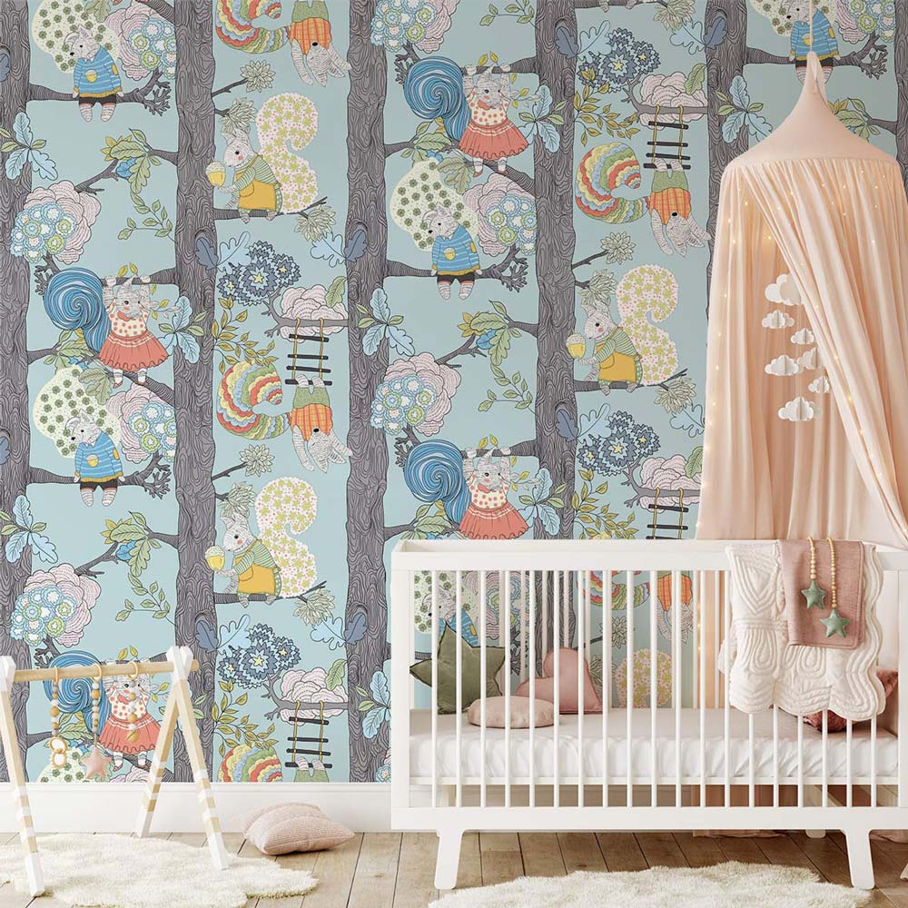 Enchanted Woodland Creatures wallpaper in kids' nursery with white cot, pastel decor, wood flooring.