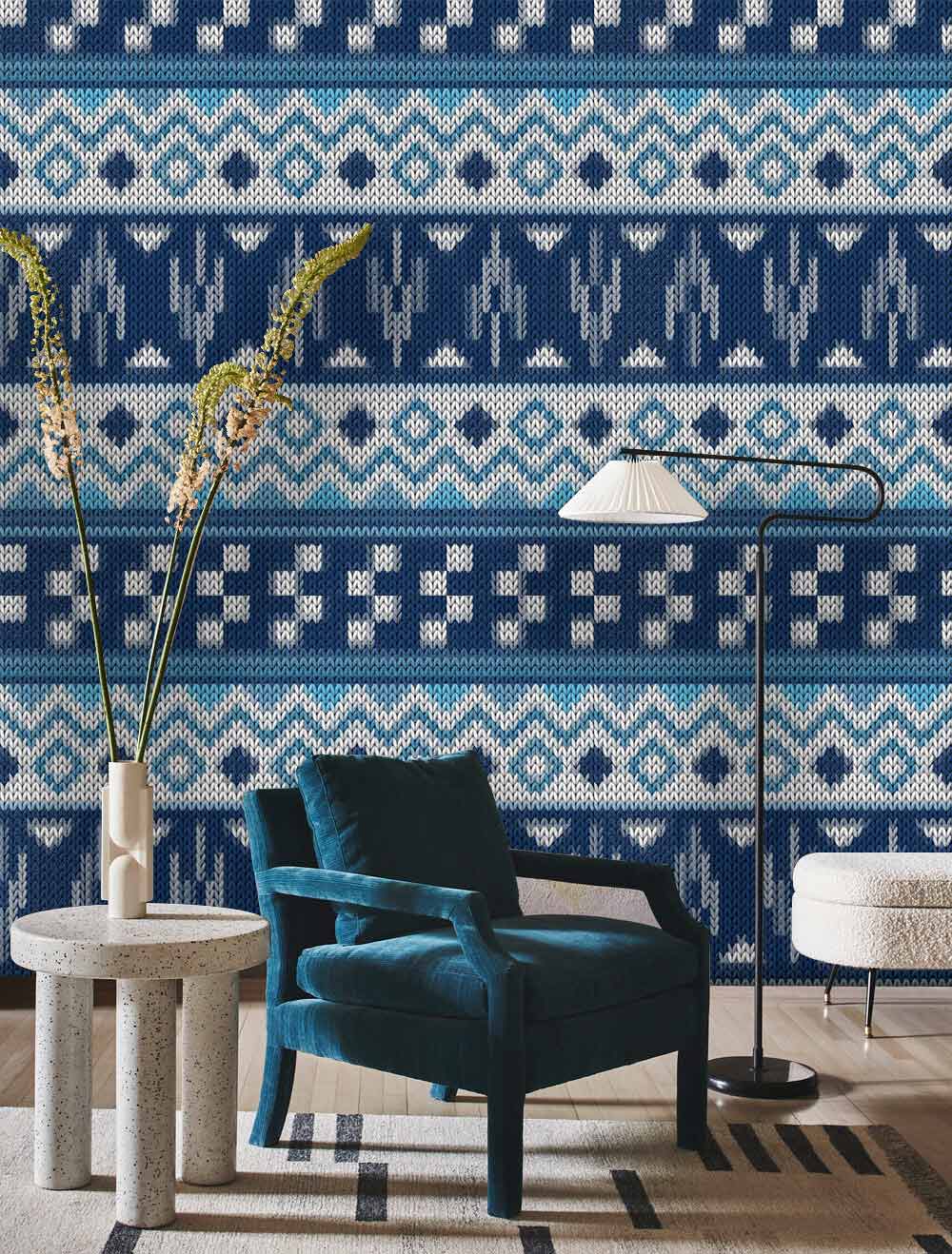 Teal chair with Nordic knit wallpaper, modern minimalist table, floor lamp, and patterned rug in living room.