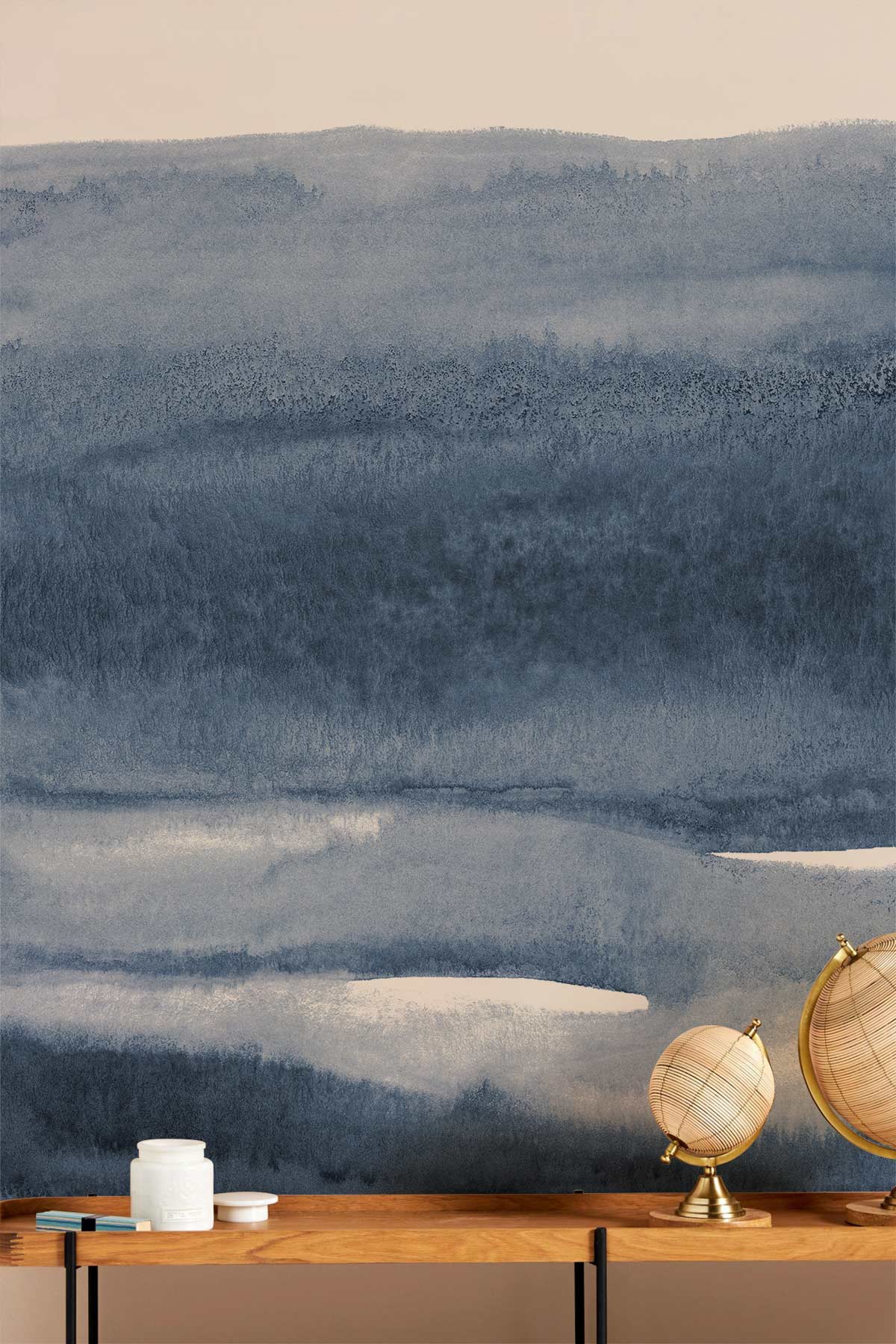 Blue Watercolour Horizon mural wallpaper with wooden console, globe decor, tranquil artistic wall decor.