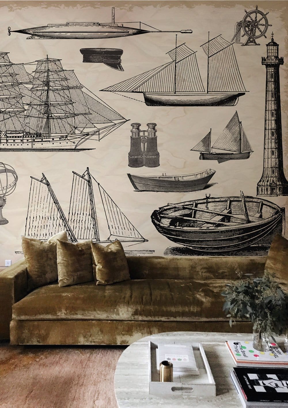 Vintage Nautical Adventures Mural Wallpaper with antique ships in a living room with brown velvet sofa.