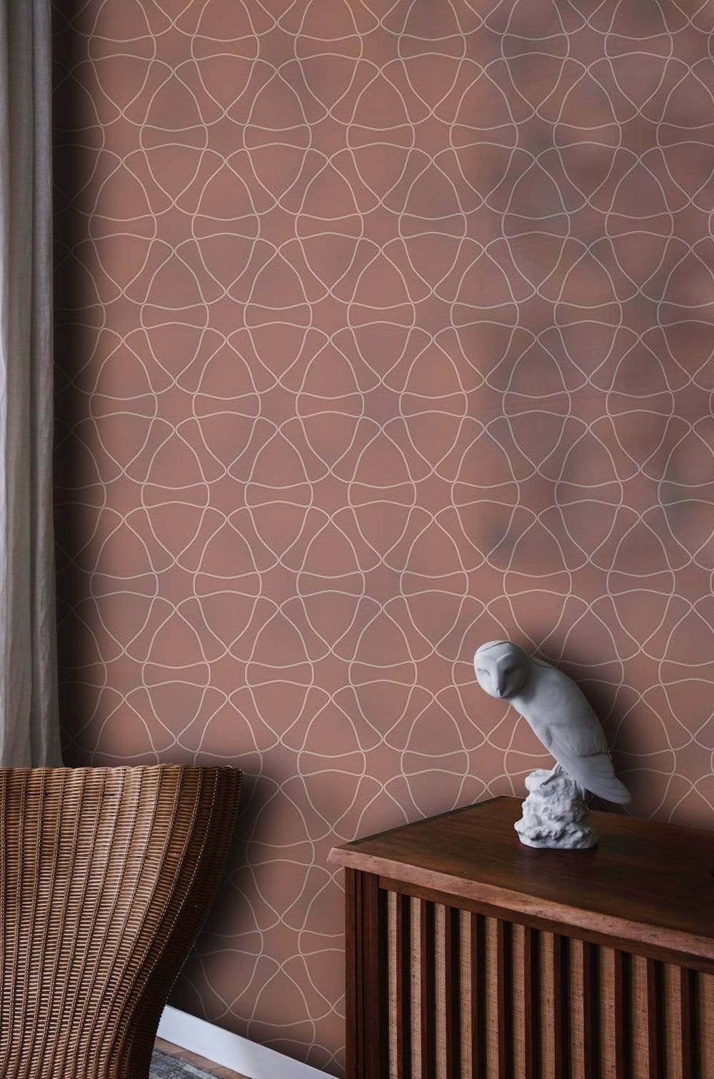 Elegant geometric wallpaper with circles, warm earthy tones, wicker chair, wooden cabinet, curtain detail.