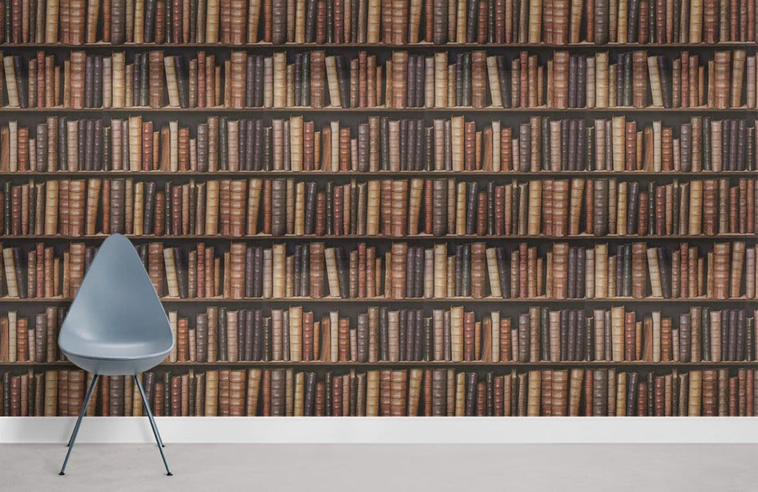 Vintage library bookshelf wallpaper, grey chair, classic brown and cream literary decor, modern flooring.