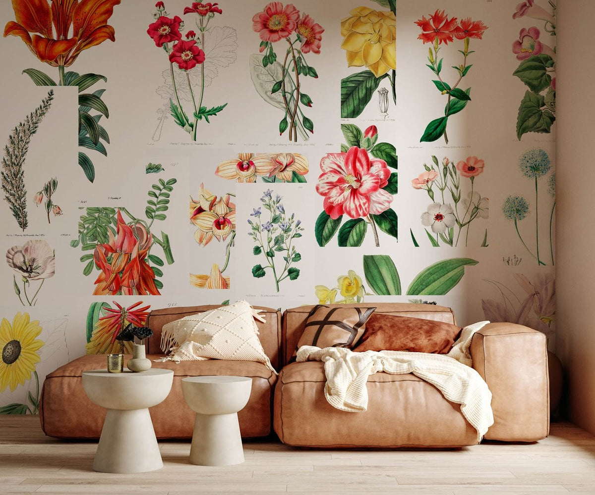 Vintage floral botanical mural wallpaper with colourful blooms, tan leather sofa, light wood flooring, rustic room.