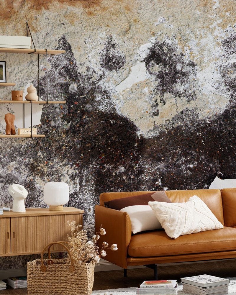 Vintage rustic mural wallpaper in earthy hues, with brown leather sofa and wooden flooring.