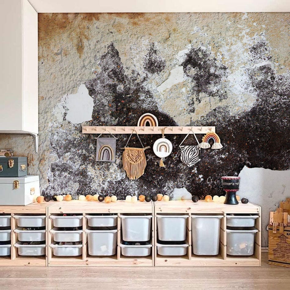 Vintage textured mural wallpaper with earthy tones in modern children's playroom, wooden storage, light flooring.