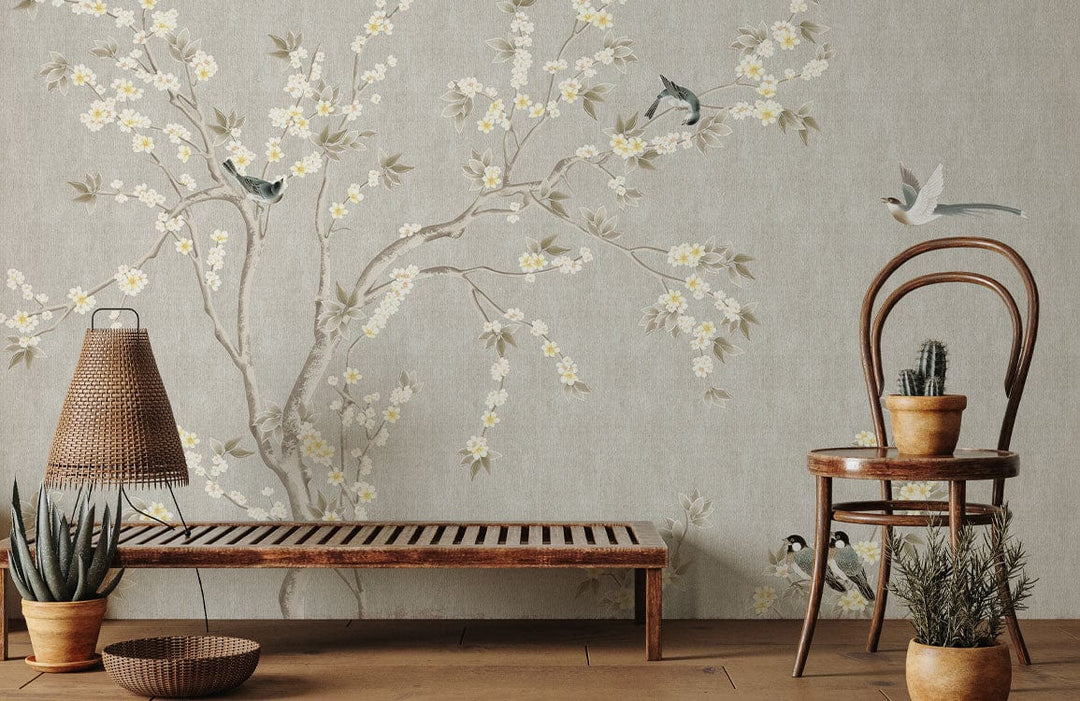 Elegant taupe Chinoiserie wallpaper with birds; vintage room with wooden bench and chair, natural flooring.