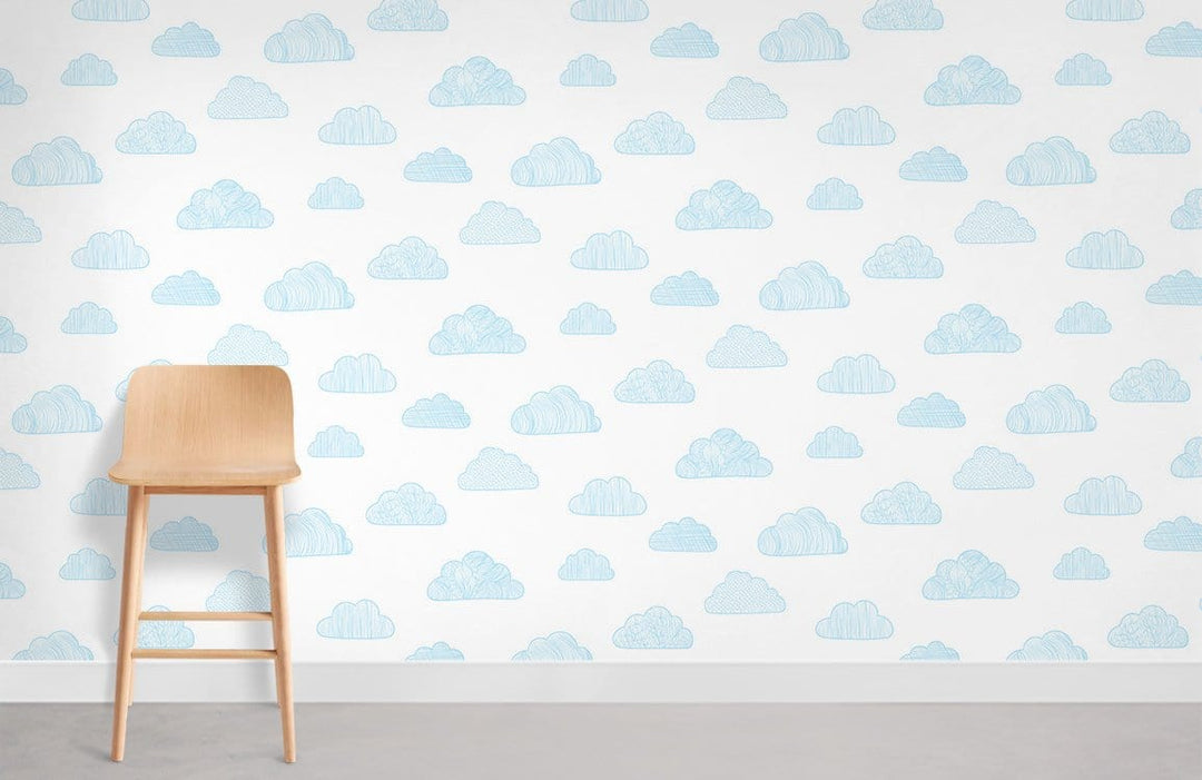 Dreamy Blue Cloud Pattern Wallpaper for nursery with light wooden chair and grey floor.