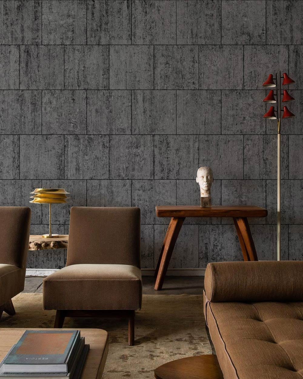 Industrial charcoal grey brick-effect wallpaper, contemporary chairs, wooden table, stylish sculptures, and dark carpet.