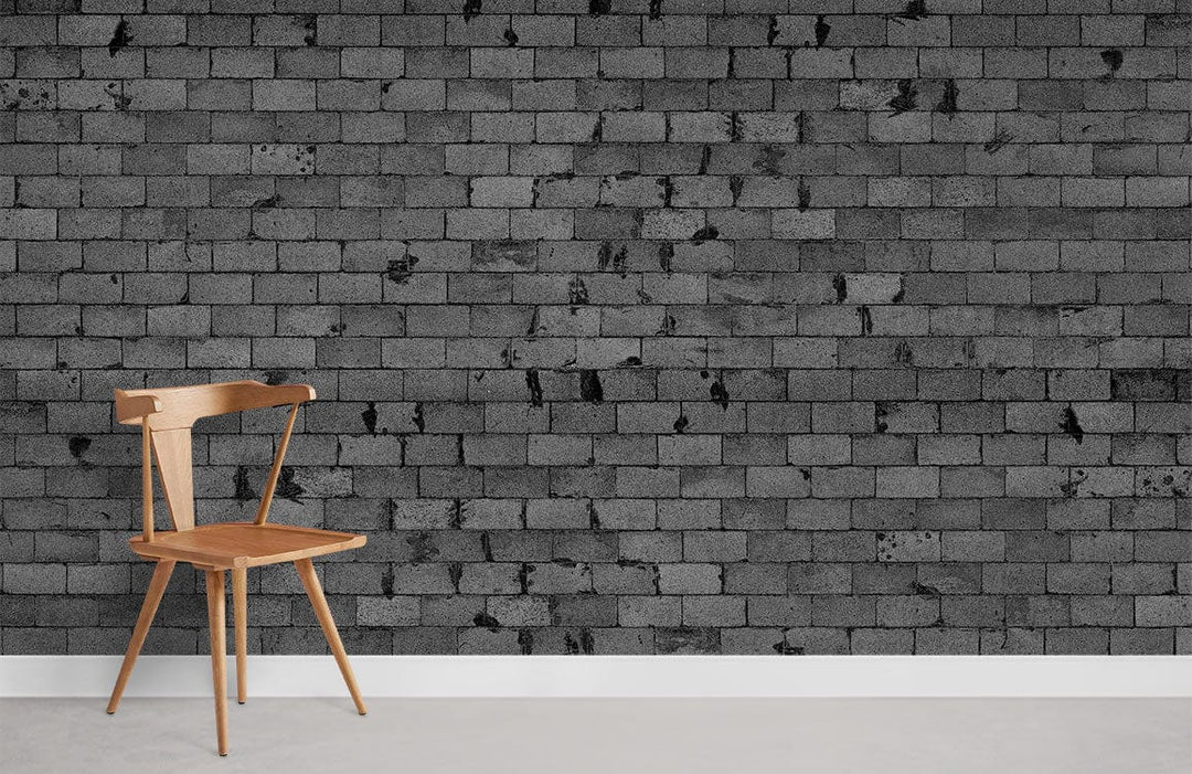 Urban Grey Brick Wall Effect Mural Wallpaper in modern room with light wooden chair and grey flooring.