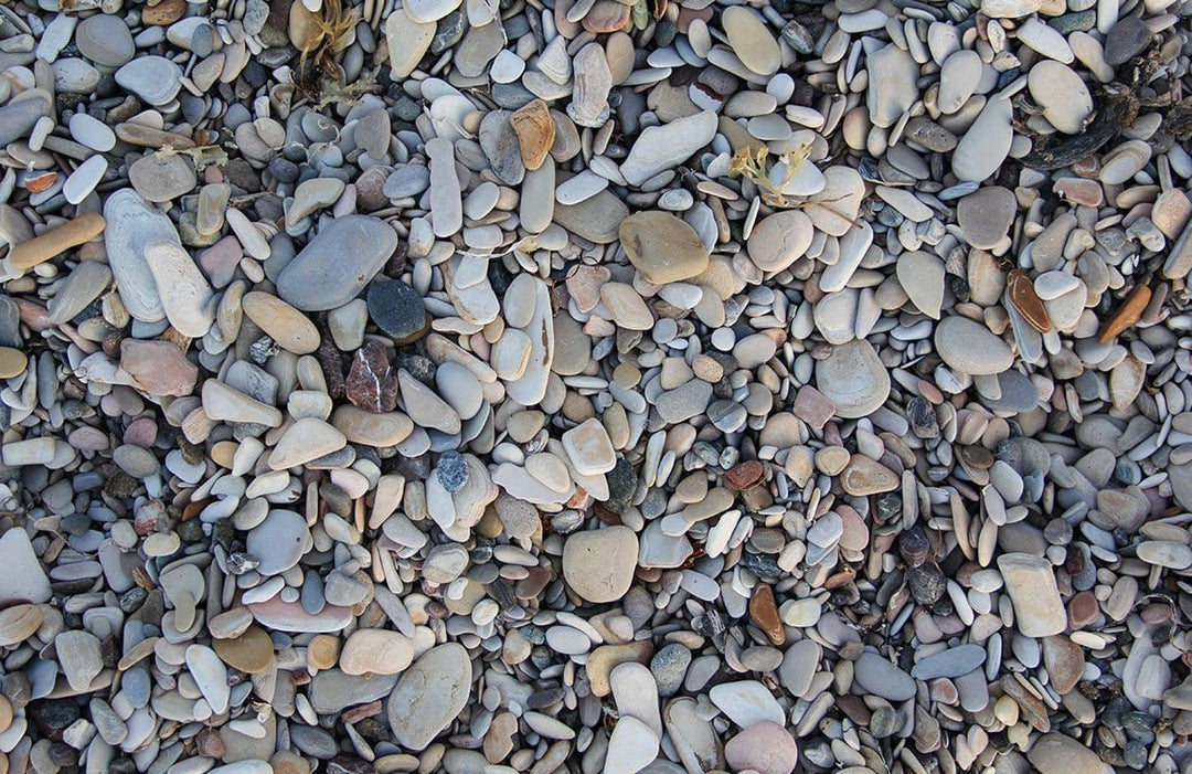 Natural Pebble Beach Stone Pattern Wallpaper in Soft Earth Tones.