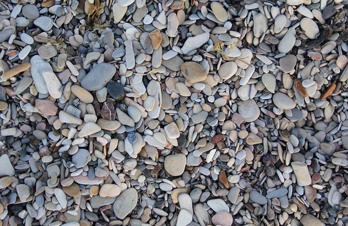 Natural Pebble Beach Stone Pattern Wallpaper in Soft Earth Tones.