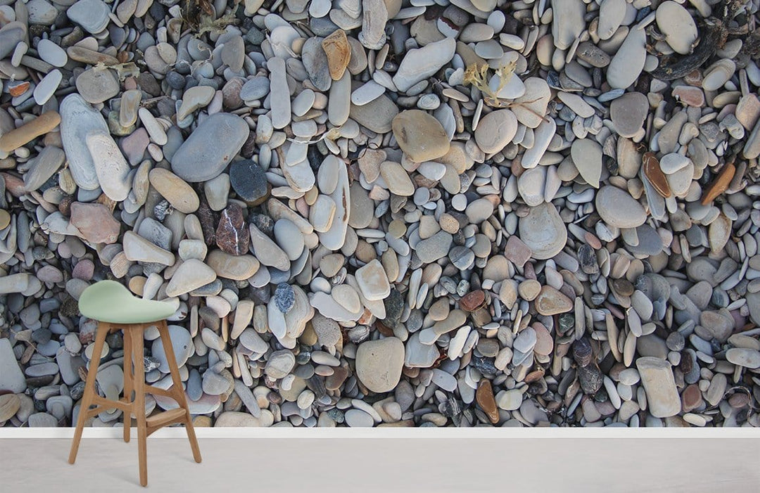 Natural Pebble Beach Stone wallpaper, stylish wooden stool, soft pebble tones, modern living room decor.