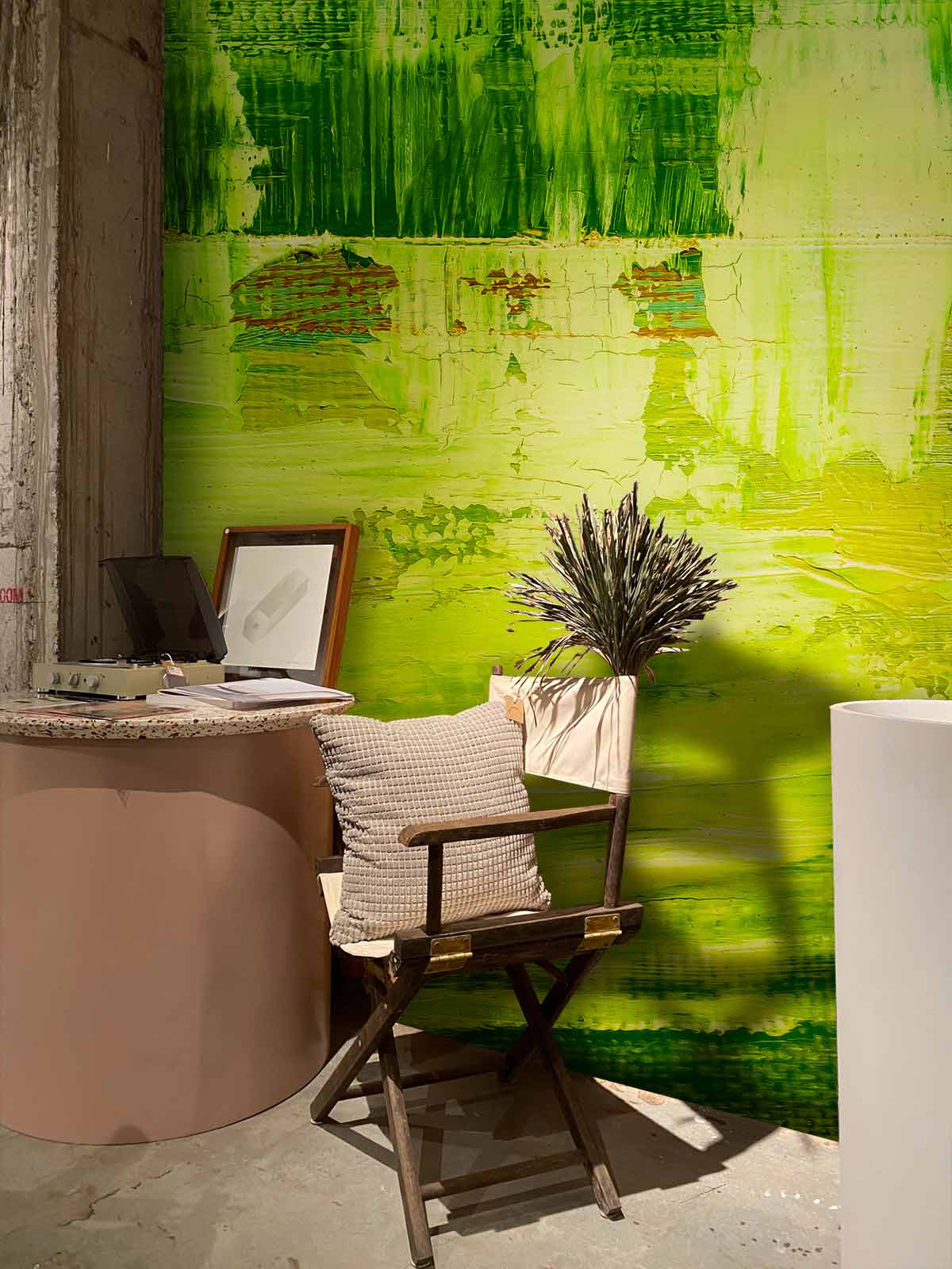 Lime abstract brushstroke textured art wallpaper, modern chair, rustic concrete floor, artistic urban interior Décor.