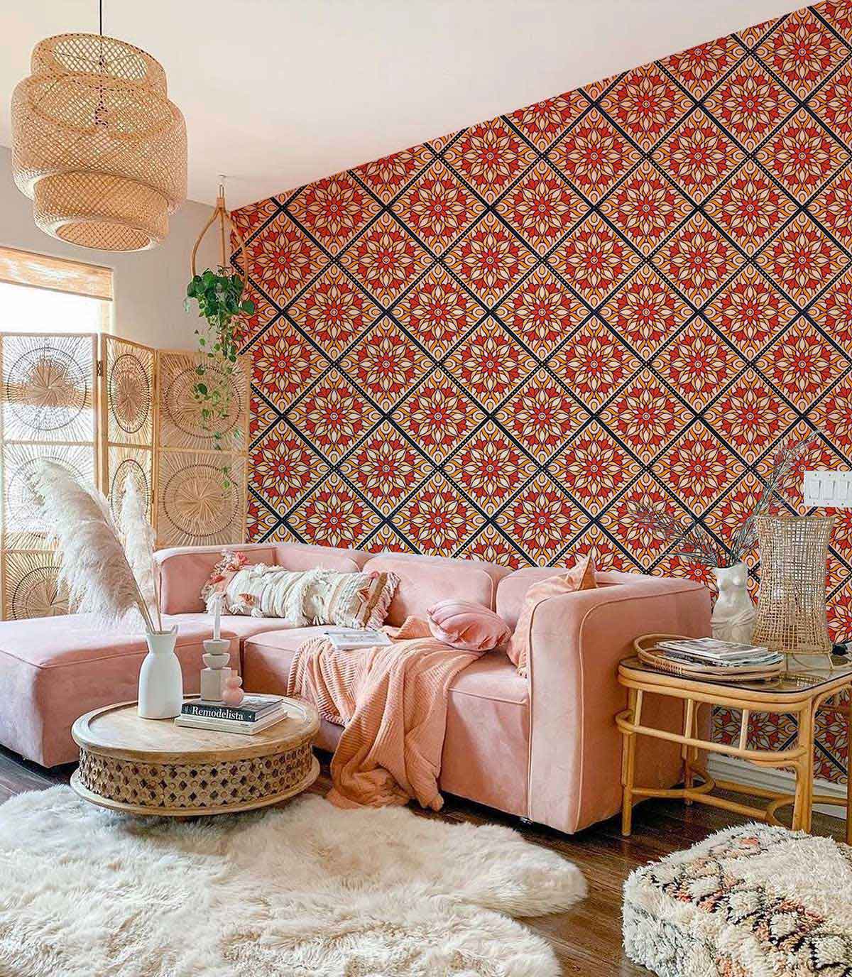 Vintage red and blue floral tile wallpaper, pink sofa, modern living room, wicker pendant light.