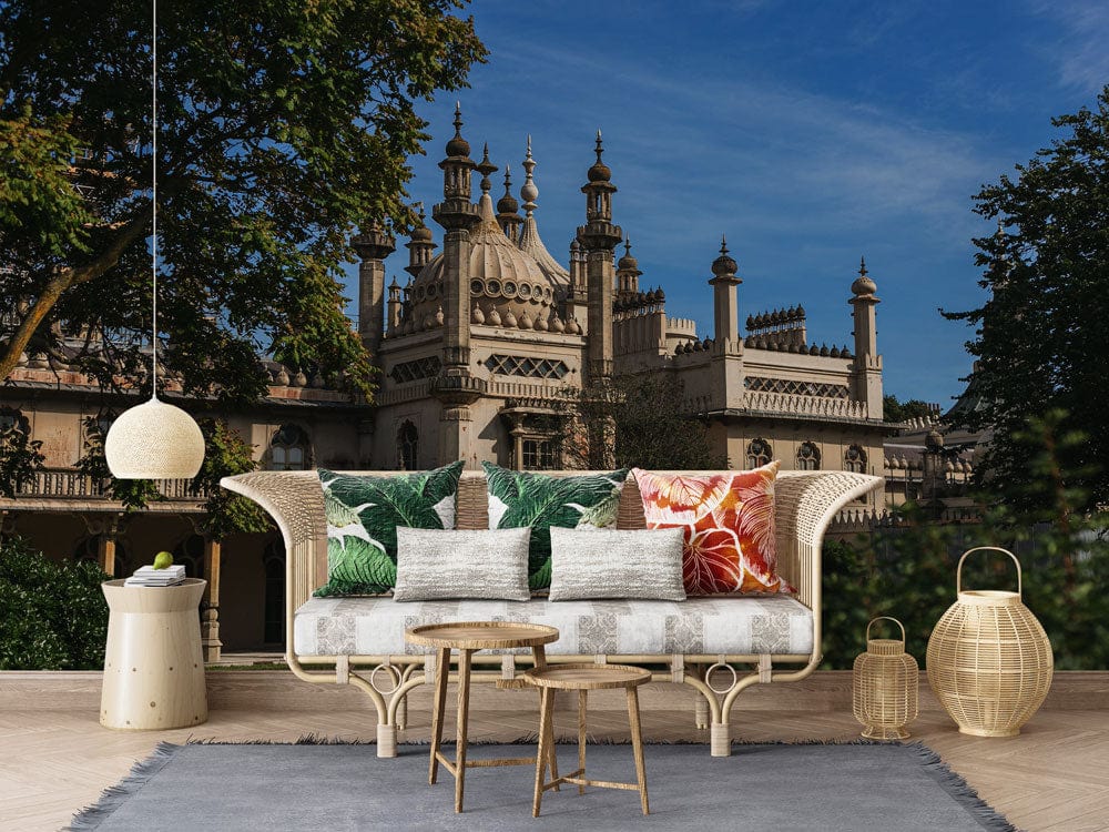 Vintage Architectural Mural Wallpaper in living room with rattan sofa, colourful cushions, and wooden tables.