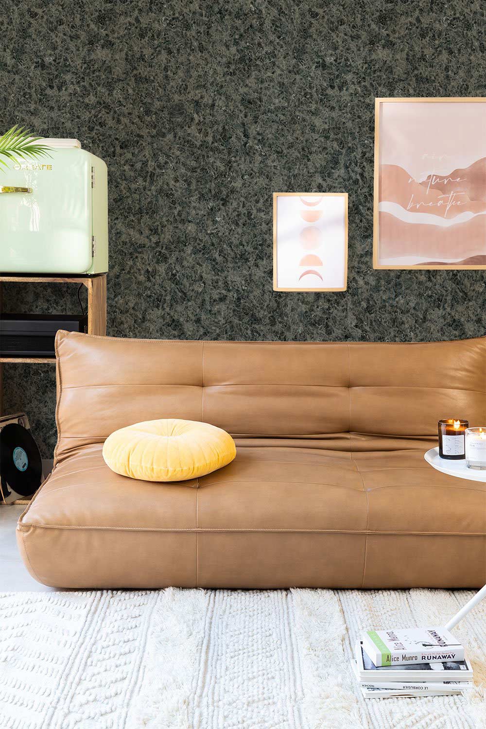 Charcoal granite-effect wallpaper, modern living room, brown leather sofa, light cream textured rug, abstract art.