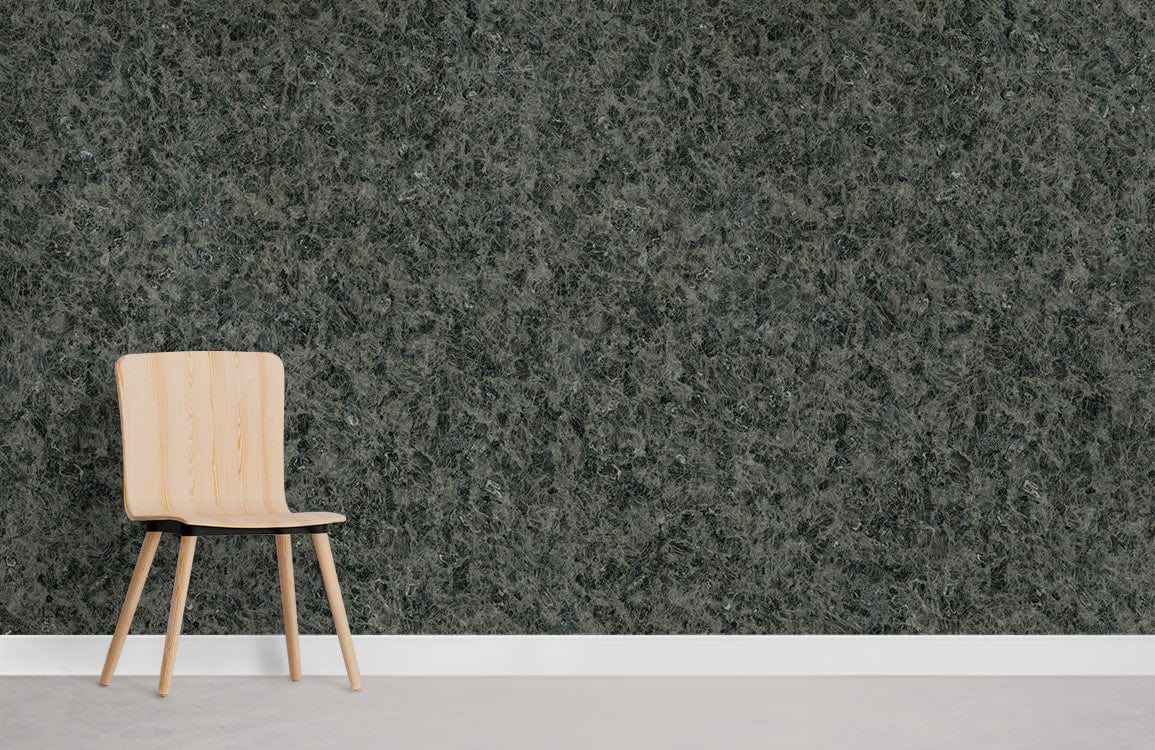 Charcoal textured granite-effect wallpaper with modern chair on grey flooring for sophisticated interiors.
