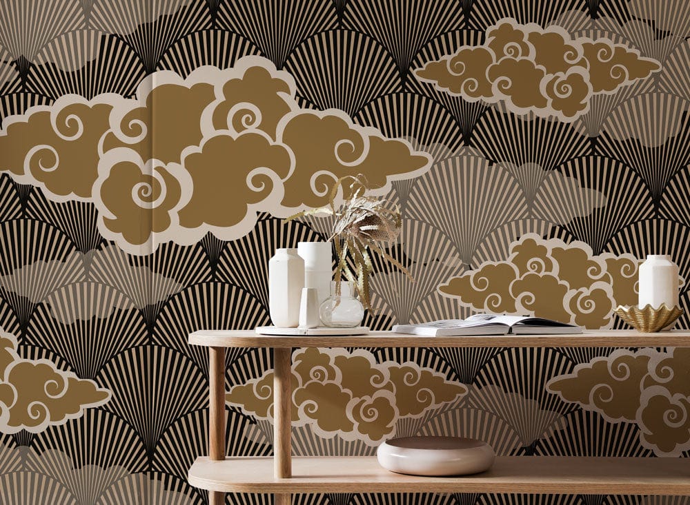 Vintage Japanese Art Deco wallpaper in gold and black, featuring fan and cloud patterns, with wooden table.