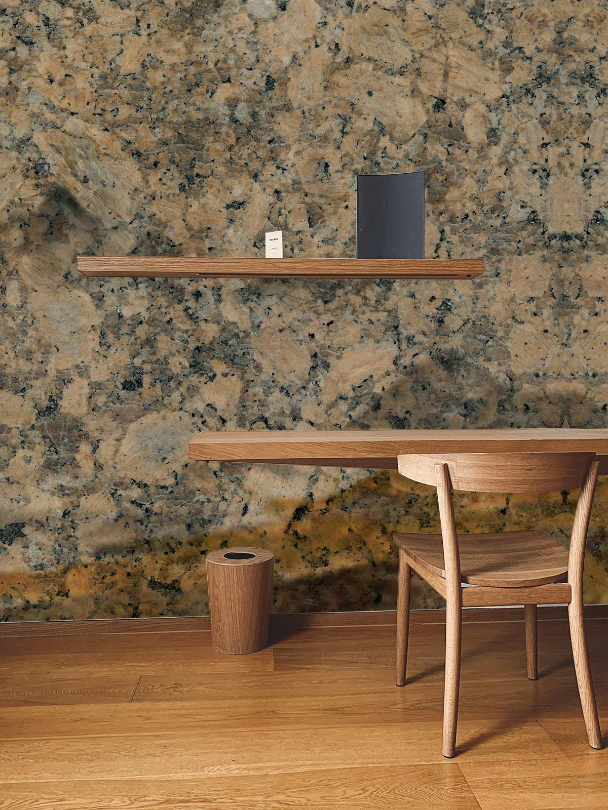 Earthy Granite Wallpaper in Beige and Grey enhances wooden desk and chair in elegant interior.