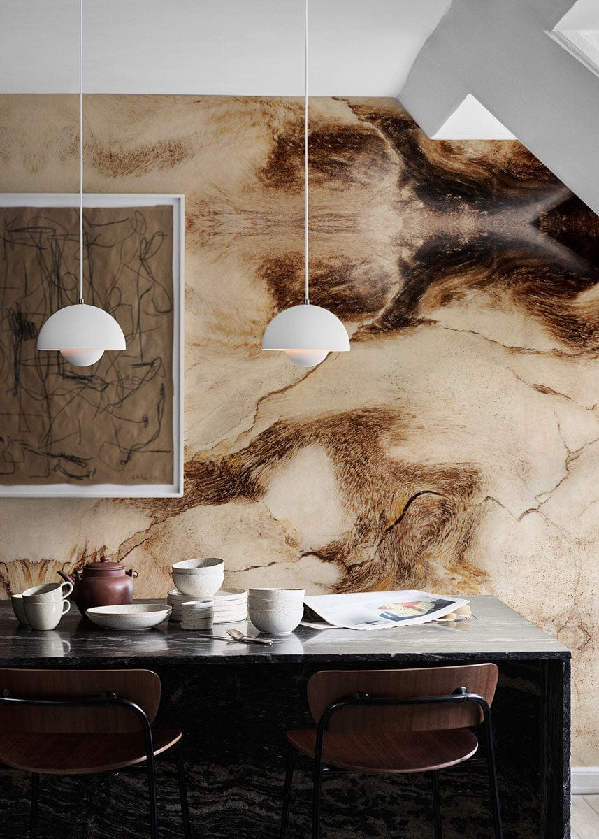 Textured Earth Tones Abstract Stone Pattern Mural Wallpaper in dining room with framed artwork and chairs.