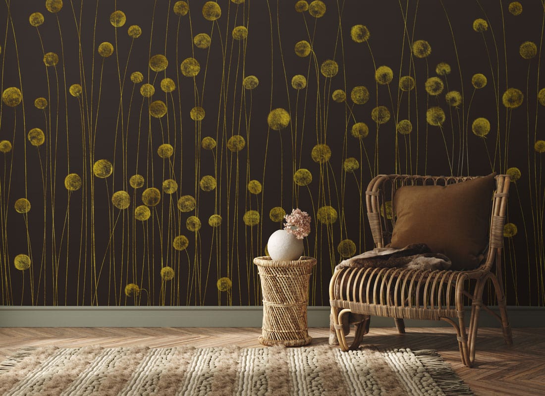 Golden Meadow floral wallpaper with wicker chair, rug, wooden flooring in a cosy living room.