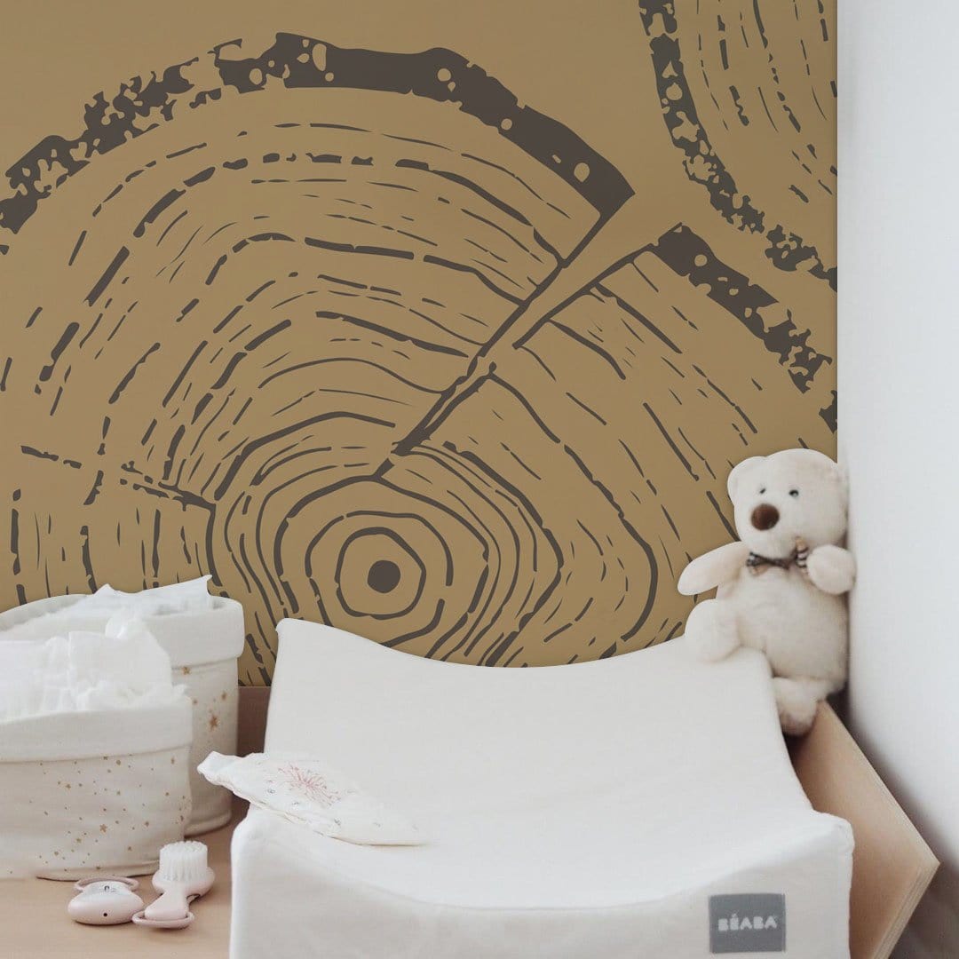 Woodsome Vintage Wallpaper showcases earthy browns; seen in nursery with changing mat and plush toy.
