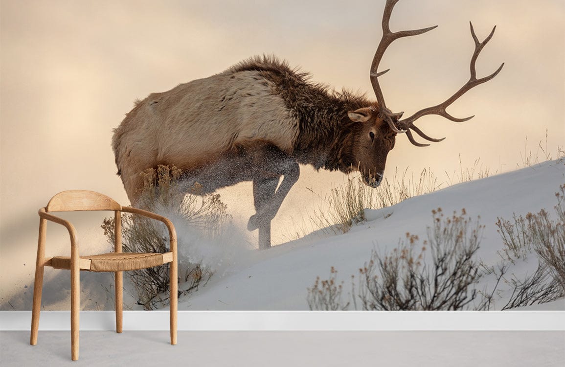 Majestic Elk Mural Wallpaper in snowy landscape, wooden chair, beige tones, modern living room.
