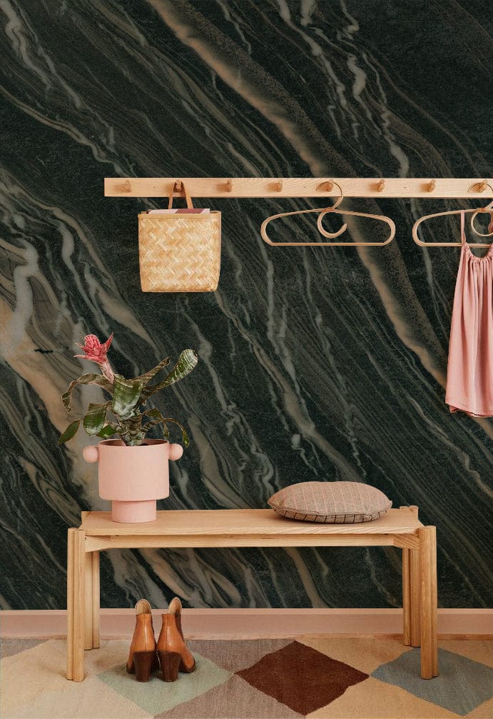 Elegant dark marble wallpaper with brown veining, wooden bench, and colourful geometric rug in hallway.