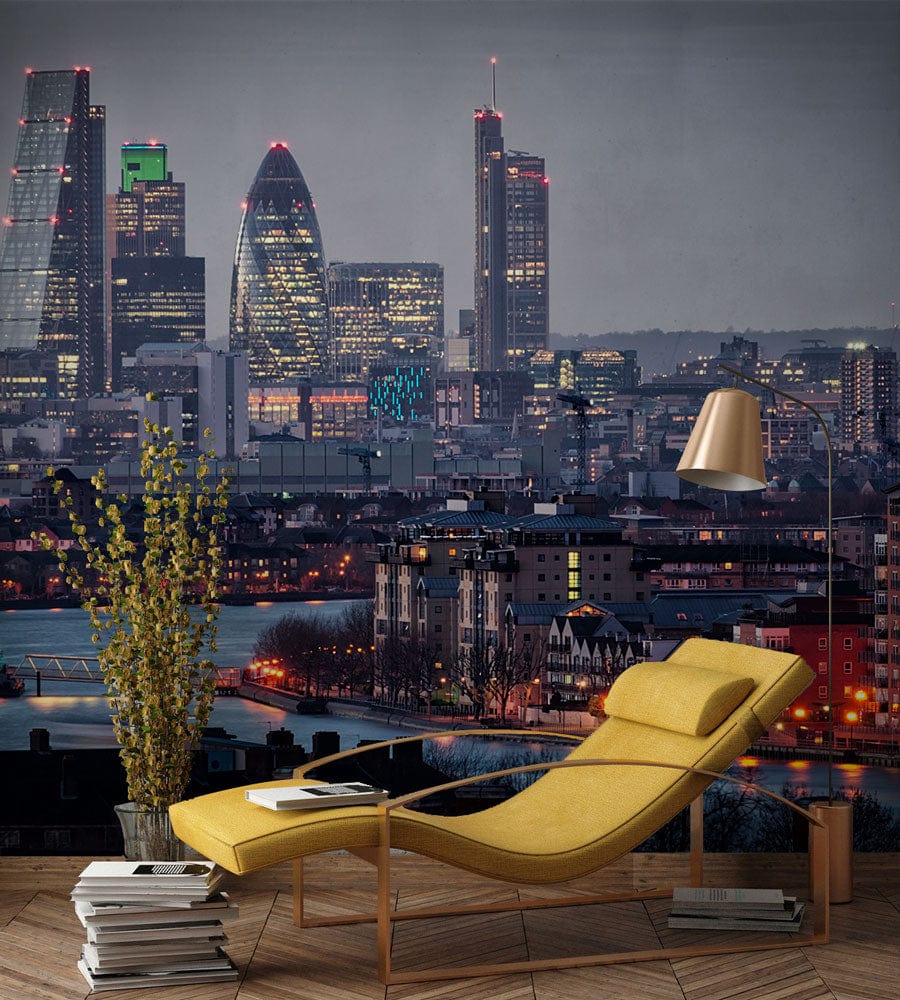 Yellow chaise longue, wooden flooring, gold floor lamp, and mural of London skyline in blue hues.