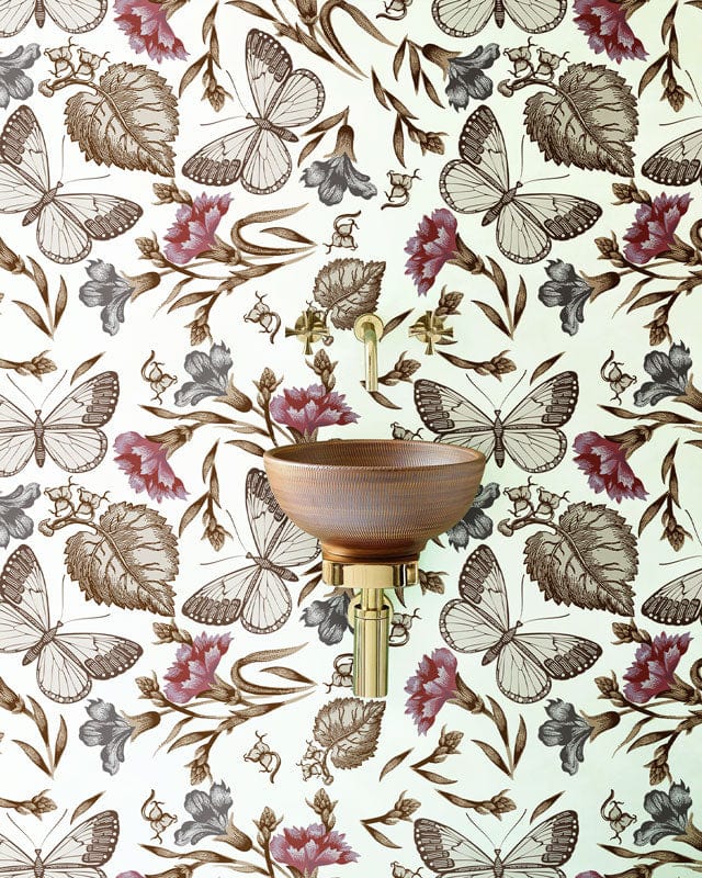 Elegant vintage floral butterfly wallpaper in earthy tones with brass wall-mounted basin in stylish bathroom.