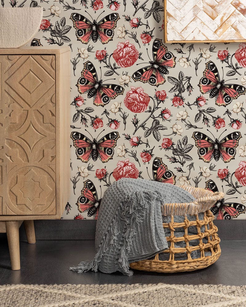 Vintage botanical butterfly floral wallpaper in red and cream with elegant wooden cabinet, wicker basket.