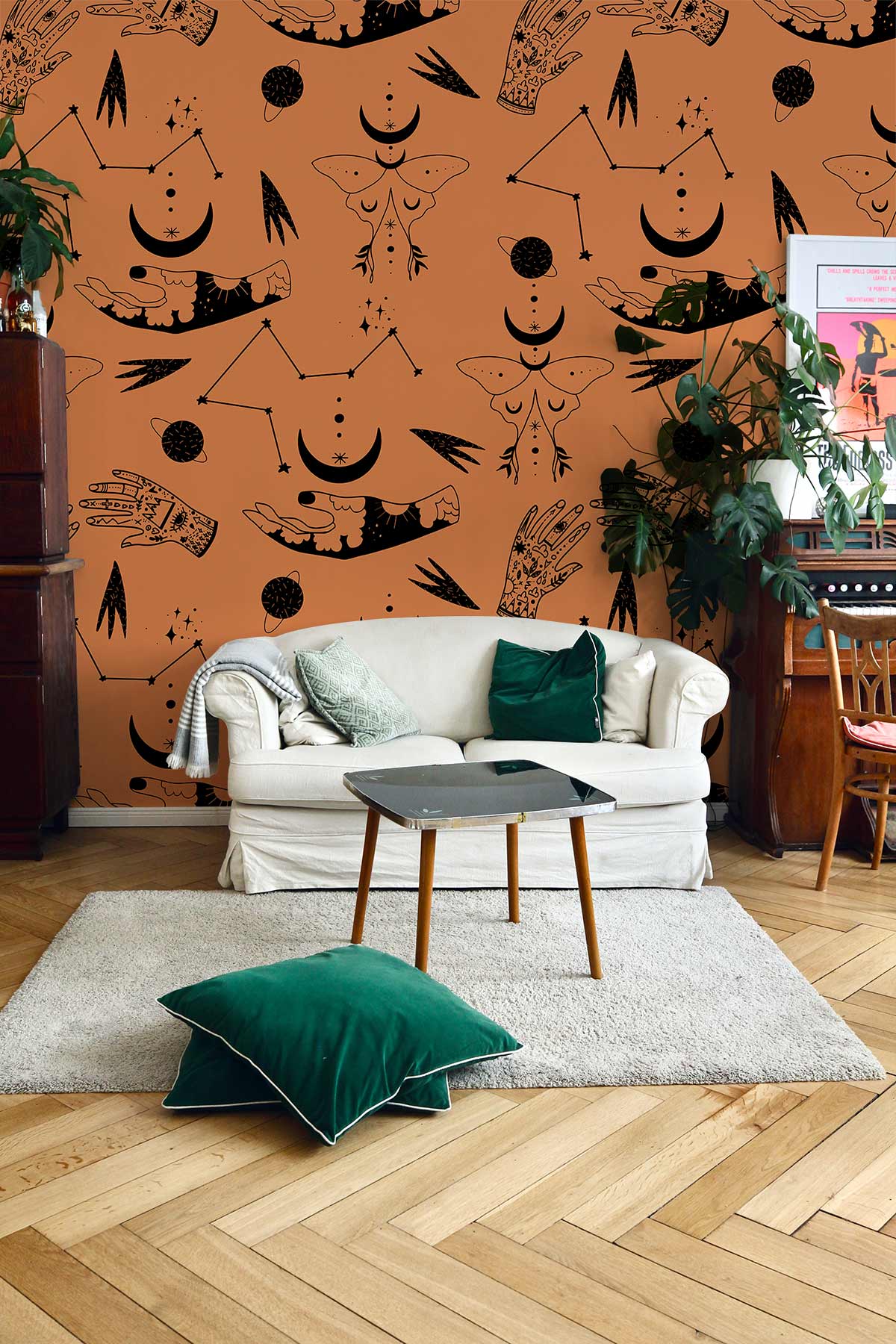 Eclectic Terracotta wallpaper with mystical motifs, cream sofa, green cushions, wooden flooring, living room.