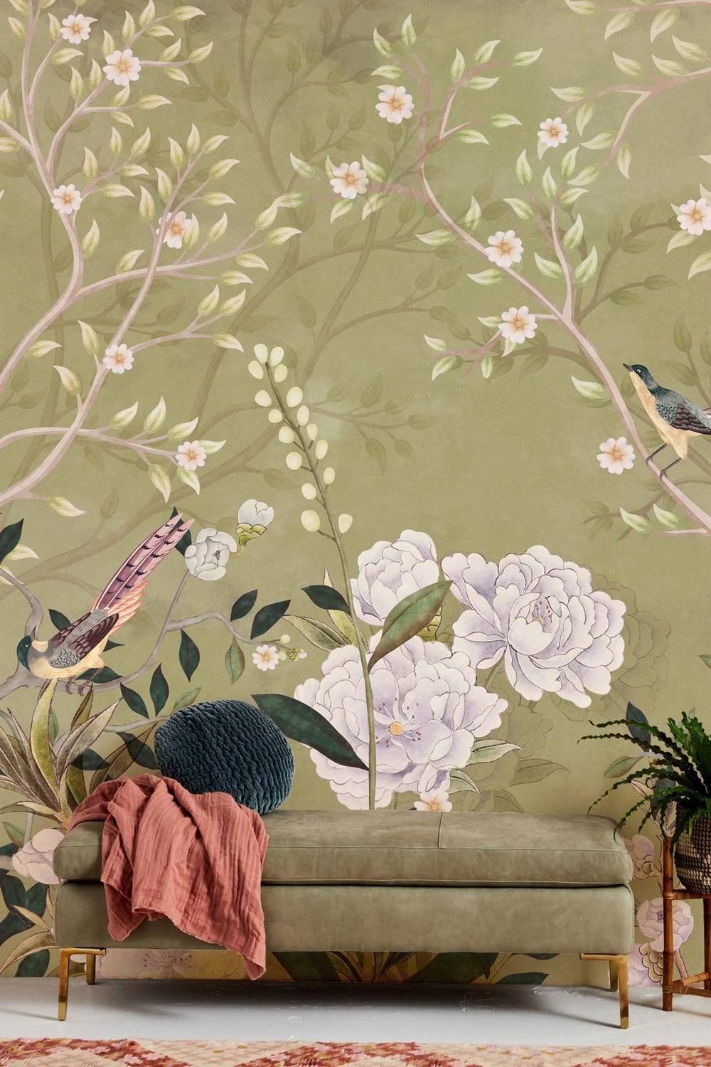Elegant green mural wallpaper with birds, blossoms; vintage design; olive sofa; elegant living room decor.