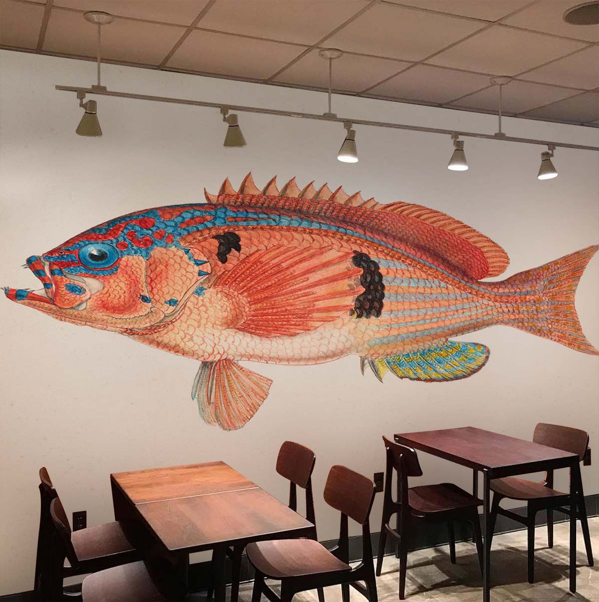 Colourful Vintage Fish Pattern Mural Wallpaper in restaurant setting with wooden tables and chairs.