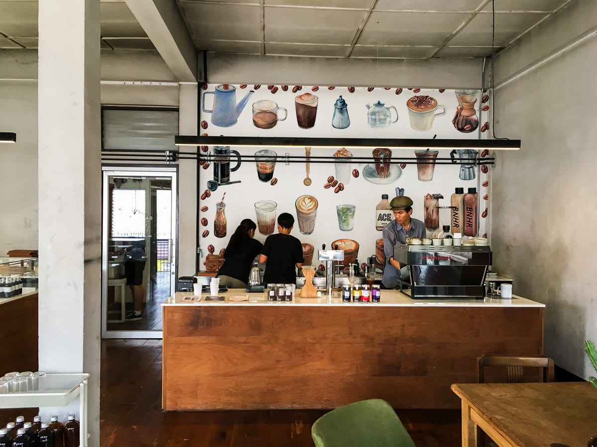 Vintage Coffee Lover's Delight watercolour mural in vibrant café setting, with wooden counter and tiled flooring.