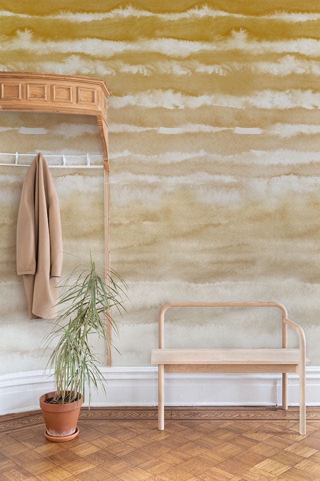 Golden Sand Watercolour Waves wallpaper with wooden bench, parquet flooring, and beige coat hanger.