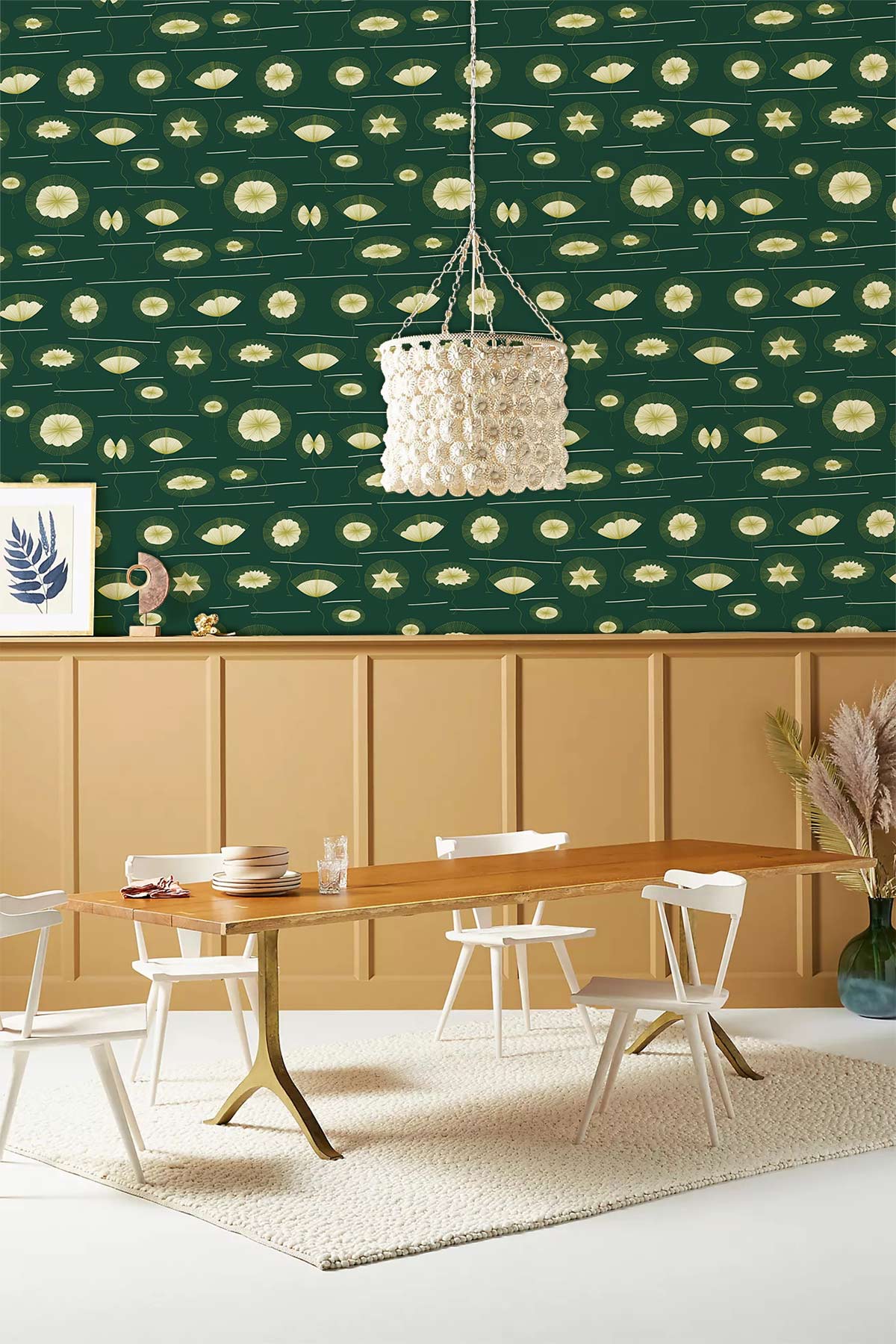 Vintage green floral wallpaper in dining room; wooden table, white chairs, beige panelled wall.
