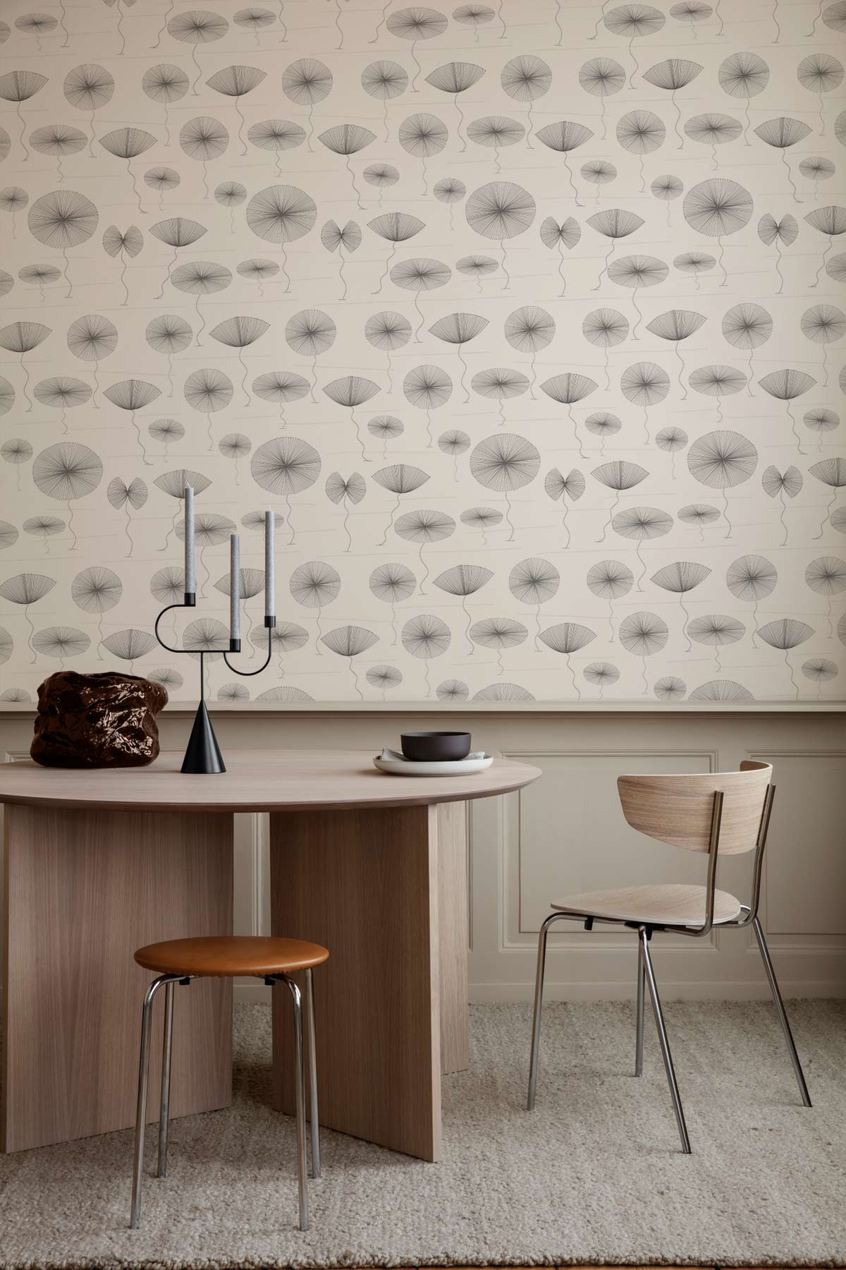 Minimalist grey abstract pattern wallpaper in dining room with modern table, wooden chair, neutral flooring.