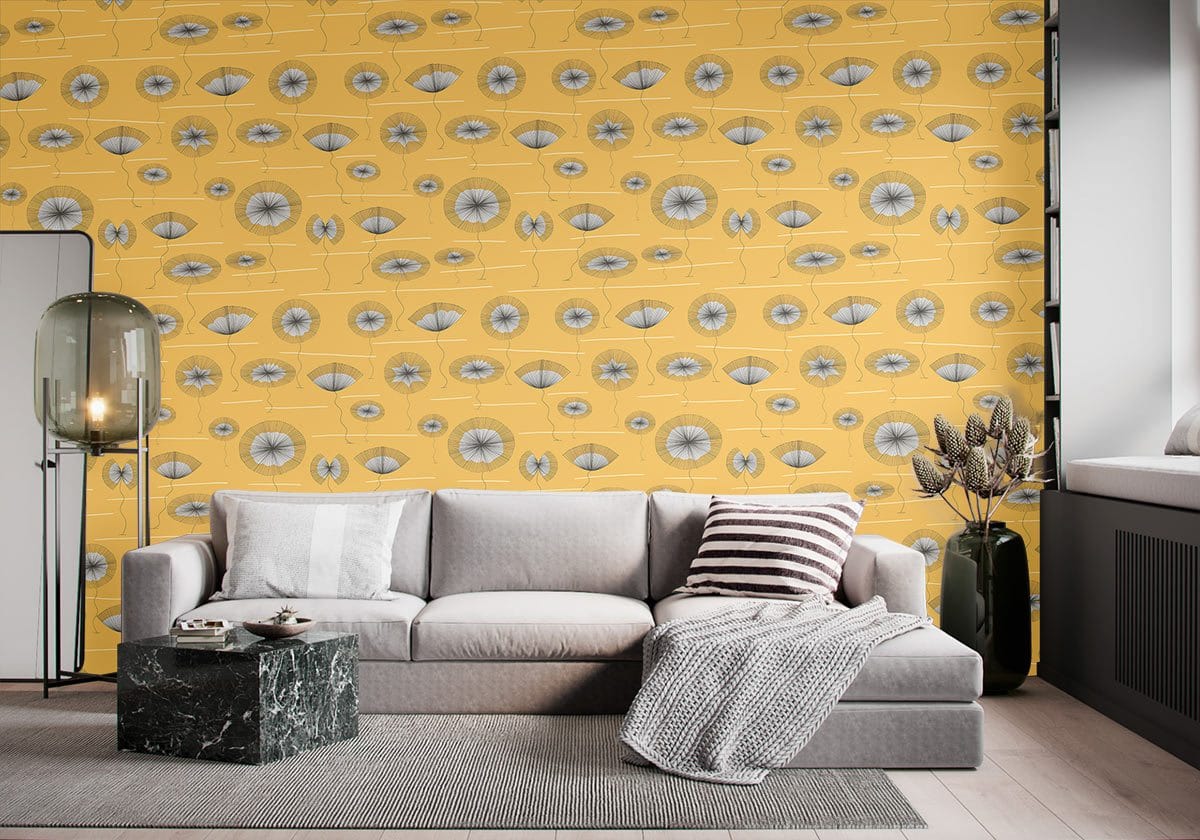 Retro mustard yellow geometric patterned wallpaper with grey sofa, marble coffee table, wooden flooring.