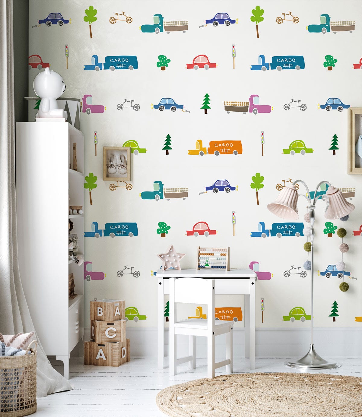 Colourful Retro Transport Nursery Wallpaper in playful cars design; features white furniture, round rug.