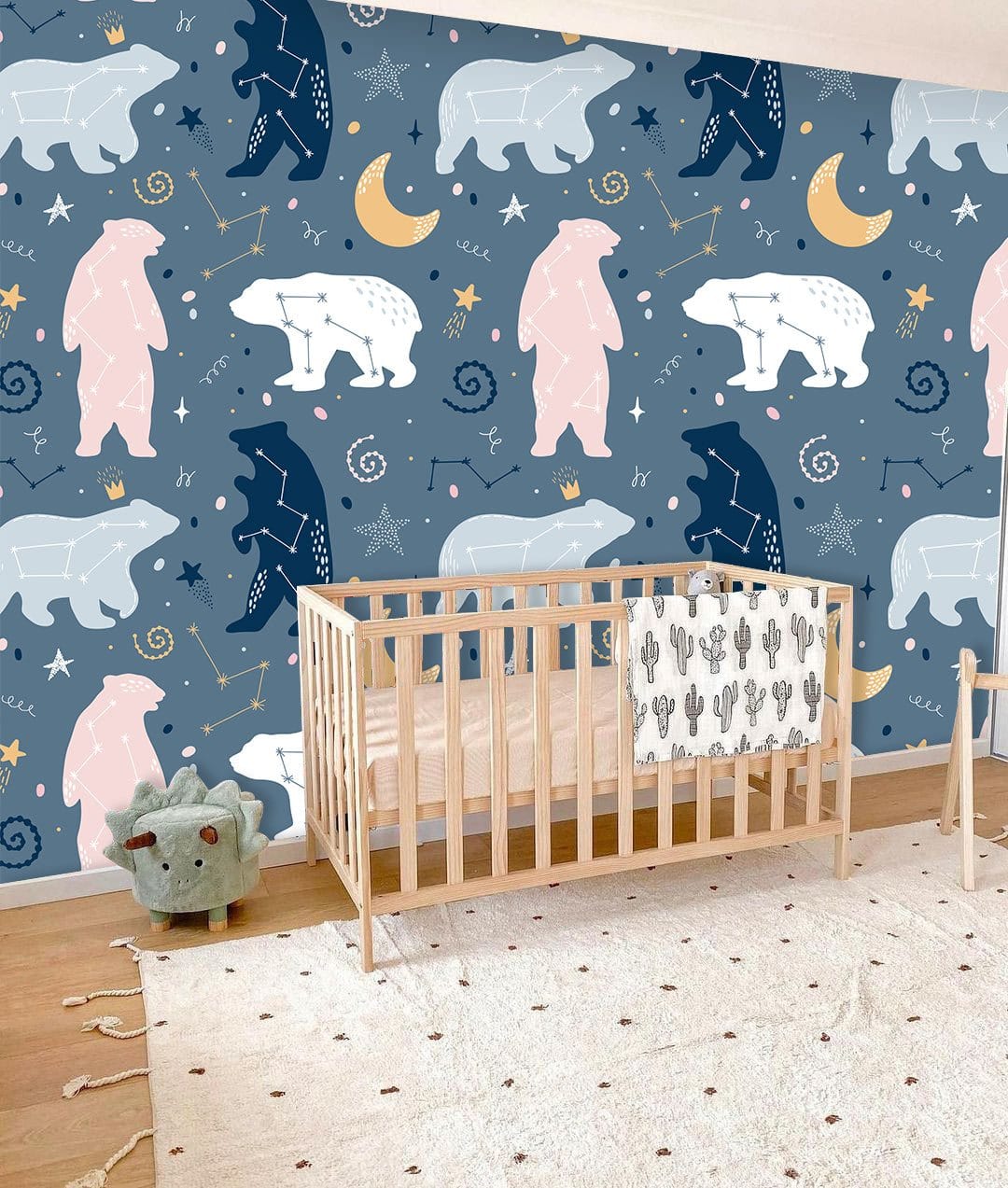 Enchanted Night Sky Bear Kids Mural Wallpaper, nursery, wooden cot, soft beige rug, hardwood flooring.