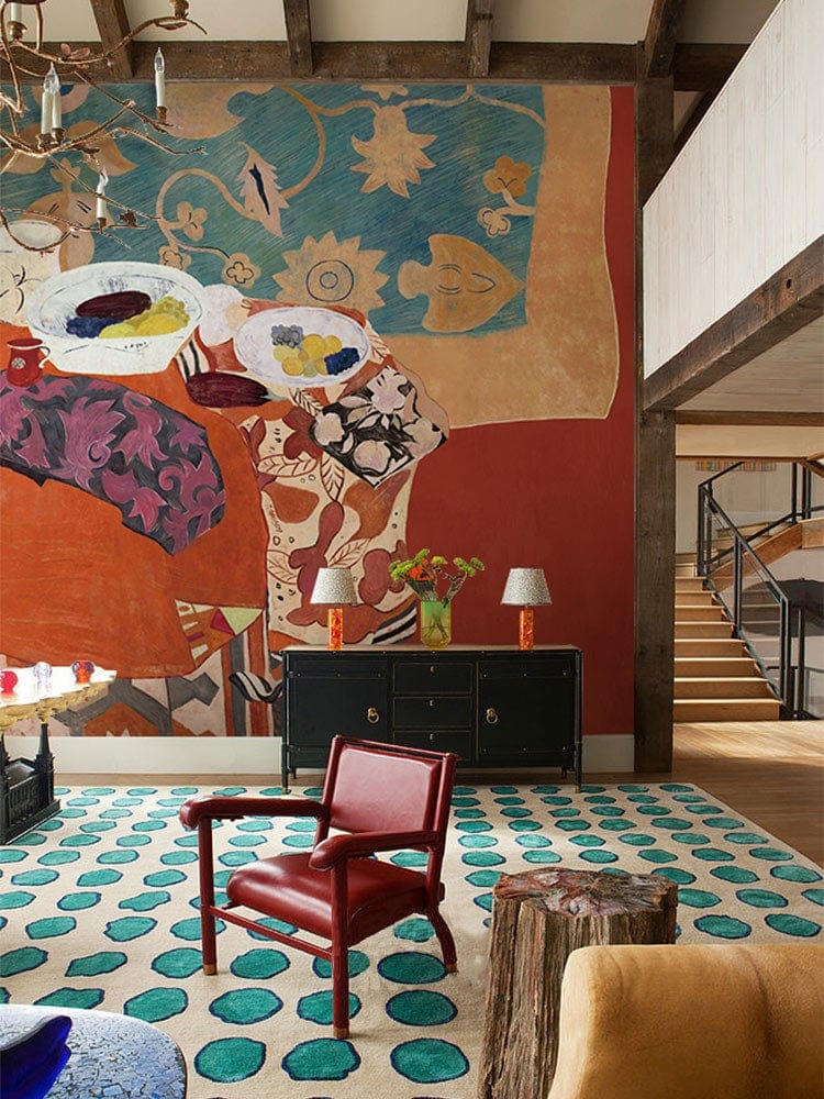 Eclectic Bohemian Feast Mural Wallpaper with vibrant patterns in living room; red chair, polka dot rug.