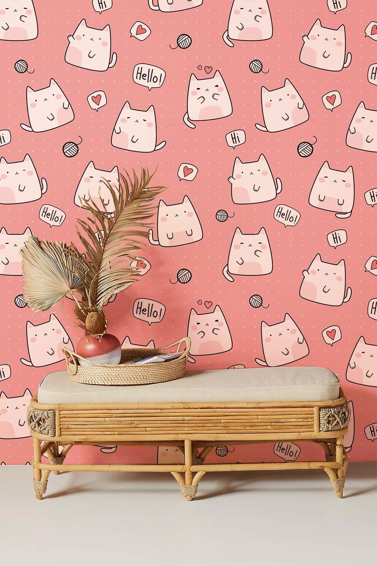 Cute cat wallpaper in pink children's room with rattan bench; playful and decorative elements.